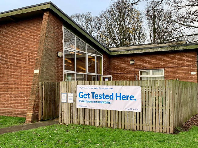 Wirral testing centre with a banner on the outside saying: Get tested here if you have no symptoms'