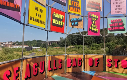 Public artwork by Morag Myserscough containing bright signs painted with words and phrases contributed by the local community that reflect what they feel about place, set on the disused site of a former gasworks