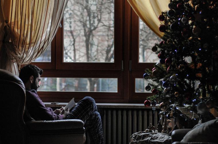 A resident at a care home sits by the window
