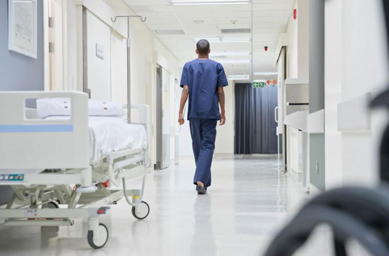 Nurse walking down a hospital hallway 