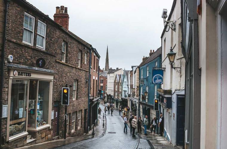 a high street with local shops in the rain