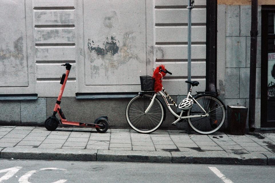 a bike and a scooter lined up next to each other in a dark road